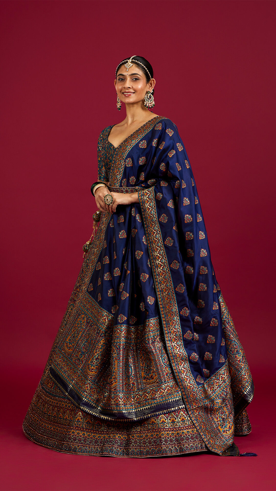 Bride in an elegant blue lehenga featuring a stylish double dupatta look.